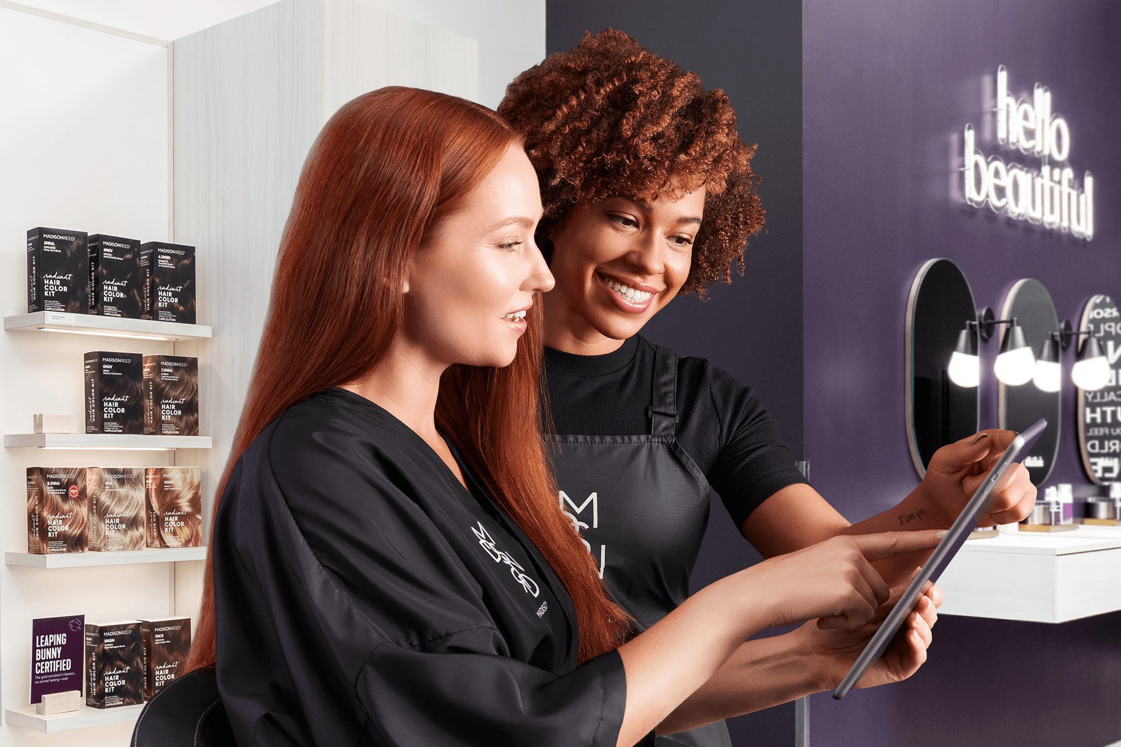 A licensed colorist consulting with a guest at a Madison Reed Color Bar
